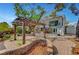 Beautiful backyard with patio area, trellises, lush greenery and a charming multi-level home at 619 D Avenue, Boulder City, NV 89005