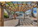 Backyard brick patio featuring a wooden pergola, hot tub, and outdoor seating areas at 619 D Avenue, Boulder City, NV 89005