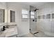 Modern bathroom features a glass shower, designer tile, and a sleek vanity with black hardware at 619 D Avenue, Boulder City, NV 89005