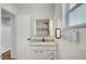 Bright bathroom with black hardware, a modern vanity with marble countertop, and glass enclosed shower at 619 D Avenue, Boulder City, NV 89005