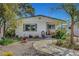 Charming single story home featuring lovely landscaping, walkway and covered porch with seating at 619 D Avenue, Boulder City, NV 89005