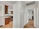 Hallway view into the kitchen featuring hardwood flooring and white cabinets at 619 D Avenue, Boulder City, NV 89005