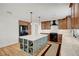 Well-lit kitchen with stainless steel appliances, marble countertops, and a gray kitchen island featuring wine storage at 619 D Avenue, Boulder City, NV 89005