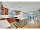 Modern kitchen with granite countertops, an island, wooden cabinets and stainless steel appliances and wood floors at 619 D Avenue, Boulder City, NV 89005