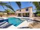 Gorgeous backyard featuring a sparkling pool, spa, covered patio, lush landscaping, and shade trees at 6489 Crest Estates St, Las Vegas, NV 89131