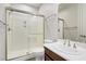 Bathroom featuring glass shower with brushed nickel hardware, white vanity, and modern fixtures at 6489 Crest Estates St, Las Vegas, NV 89131
