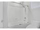 Bathroom featuring enclosed shower-tub, white tiling and a bright and clean design at 6489 Crest Estates St, Las Vegas, NV 89131