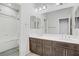 Bathroom featuring double sinks, modern fixtures, a large mirror, and shower-tub combination at 6489 Crest Estates St, Las Vegas, NV 89131