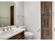 Bathroom featuring a vanity, toilet, and storage cabinet at 6489 Crest Estates St, Las Vegas, NV 89131
