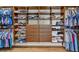 Walk-in closet featuring custom wood shelving and ample storage space for clothing and accessories at 6489 Crest Estates St, Las Vegas, NV 89131
