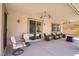 Relaxing covered patio with comfortable seating, ceiling fans, and views of the backyard oasis at 6489 Crest Estates St, Las Vegas, NV 89131