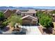 Charming two-story home with a well-maintained lawn, mature trees, and a spacious three-car garage at 6489 Crest Estates St, Las Vegas, NV 89131
