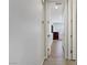 Hallway leading into bedroom with wood floors, open doorway, and neutral paint at 6489 Crest Estates St, Las Vegas, NV 89131