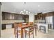 Spacious kitchen with dark cabinetry, stainless steel appliances, and adjacent dining area at 6489 Crest Estates St, Las Vegas, NV 89131
