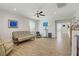 Open living room with hardwood floors, neutral paint, ceiling fan, and bright natural light at 6489 Crest Estates St, Las Vegas, NV 89131