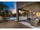 Inviting covered patio with ceiling fans and a view of the refreshing pool and lush landscaping at 6489 Crest Estates St, Las Vegas, NV 89131