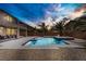 Backyard view of private pool and spa complemented by a covered patio and desert landscaping at 6489 Crest Estates St, Las Vegas, NV 89131