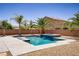 Inviting backyard pool and spa area, beautifully landscaped with desert plants and mature palm trees at 6489 Crest Estates St, Las Vegas, NV 89131