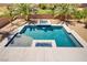 Aerial view of a backyard swimming pool with a spa and desert landscaping including large palm trees and greenery at 6489 Crest Estates St, Las Vegas, NV 89131