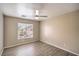 Bedroom featuring wood-look floors, neutral walls, and a window for natural light at 6617 Lavender Lilly Ln # 1, North Las Vegas, NV 89084