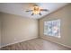 Cozy bedroom featuring wood-look floors, a ceiling fan, and a window for natural light at 6617 Lavender Lilly Ln # 1, North Las Vegas, NV 89084