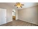 Bright bedroom showcasing wood-look floors and an arched doorway to the bathroom at 6617 Lavender Lilly Ln # 1, North Las Vegas, NV 89084