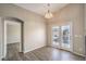 Cozy dining area featuring wood-look floors, french doors, and a charming chandelier at 6617 Lavender Lilly Ln # 1, North Las Vegas, NV 89084