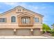Inviting exterior view of a three-car garage townhome with a small, quaint balcony at 6617 Lavender Lilly Ln # 1, North Las Vegas, NV 89084