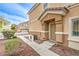 Inviting townhouse front entrance with desert landscaping, a door, and a paved walkway at 6617 Lavender Lilly Ln # 1, North Las Vegas, NV 89084