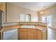 Well-lit kitchen featuring a breakfast bar, double sink, and neutral finishes at 6617 Lavender Lilly Ln # 1, North Las Vegas, NV 89084