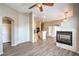 Open-concept living space with modern fireplace, wood-look floors, and natural light at 6617 Lavender Lilly Ln # 1, North Las Vegas, NV 89084