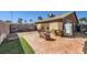 Expansive backyard with a brick patio, fire pit, and potential for outdoor living at 7047 Mountain Meadow Ln, Las Vegas, NV 89147