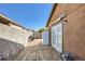 Side yard with a wood deck, grill, and convenient access to the house through glass doors at 7047 Mountain Meadow Ln, Las Vegas, NV 89147