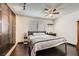 Bedroom with built-in closet, ceiling fan, and dark wood floors at 7047 Mountain Meadow Ln, Las Vegas, NV 89147