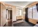 Bright bedroom with a dresser, closet, and a large window providing natural light at 7047 Mountain Meadow Ln, Las Vegas, NV 89147