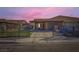 Charming single-story home featuring a gated front yard and covered parking at 7047 Mountain Meadow Ln, Las Vegas, NV 89147