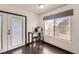 Compact eat-in kitchen featuring a breakfast table, a large window, and backyard access at 7047 Mountain Meadow Ln, Las Vegas, NV 89147
