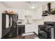 Well-lit kitchen boasting modern black appliances, white cabinets, and sleek countertops at 7047 Mountain Meadow Ln, Las Vegas, NV 89147