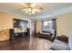 Inviting living room boasts dark hardwood floors, a ceiling fan, and a cozy seating area at 7047 Mountain Meadow Ln, Las Vegas, NV 89147