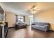 Bright living room with hardwood floors, a ceiling fan, and ample seating at 7047 Mountain Meadow Ln, Las Vegas, NV 89147