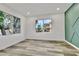 Bedroom with hardwood flooring, two large windows, and a decorative accent wall at 7909 Smokey Ridge Ct, Las Vegas, NV 89131