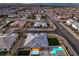 Wide aerial perspective of a residential area featuring a home with a pool and green lawn at 8445 S Tenaya Way, Las Vegas, NV 89113