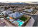 Stunning aerial view of a modern home with a pool, spa, and lush green lawn at 8445 S Tenaya Way, Las Vegas, NV 89113