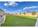 Expansive backyard with lush green grass, mature trees, and secure brick fencing, creating a private oasis at 8445 S Tenaya Way, Las Vegas, NV 89113