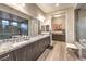 This bright bathroom has dual sinks, granite counters, a separate water closet, and modern cabinetry at 8445 S Tenaya Way, Las Vegas, NV 89113