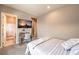 Bedroom featuring a desk, television, and a view of the bathroom with a tiled walk-in shower at 8445 S Tenaya Way, Las Vegas, NV 89113