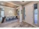 The dining area is spacious and bright, showcasing modern lighting and decor with an adjacent entryway at 8445 S Tenaya Way, Las Vegas, NV 89113