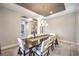 Elegant dining room features a long wooden table and stylish chandelier lighting at 8445 S Tenaya Way, Las Vegas, NV 89113