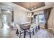 Bright dining room with pendant lighting, multiple windows with sheer curtains and decorative rug at 8445 S Tenaya Way, Las Vegas, NV 89113