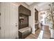A convenient entryway with a built-in bench, storage cabinets, coat hooks, and stylish granite countertop at 8445 S Tenaya Way, Las Vegas, NV 89113